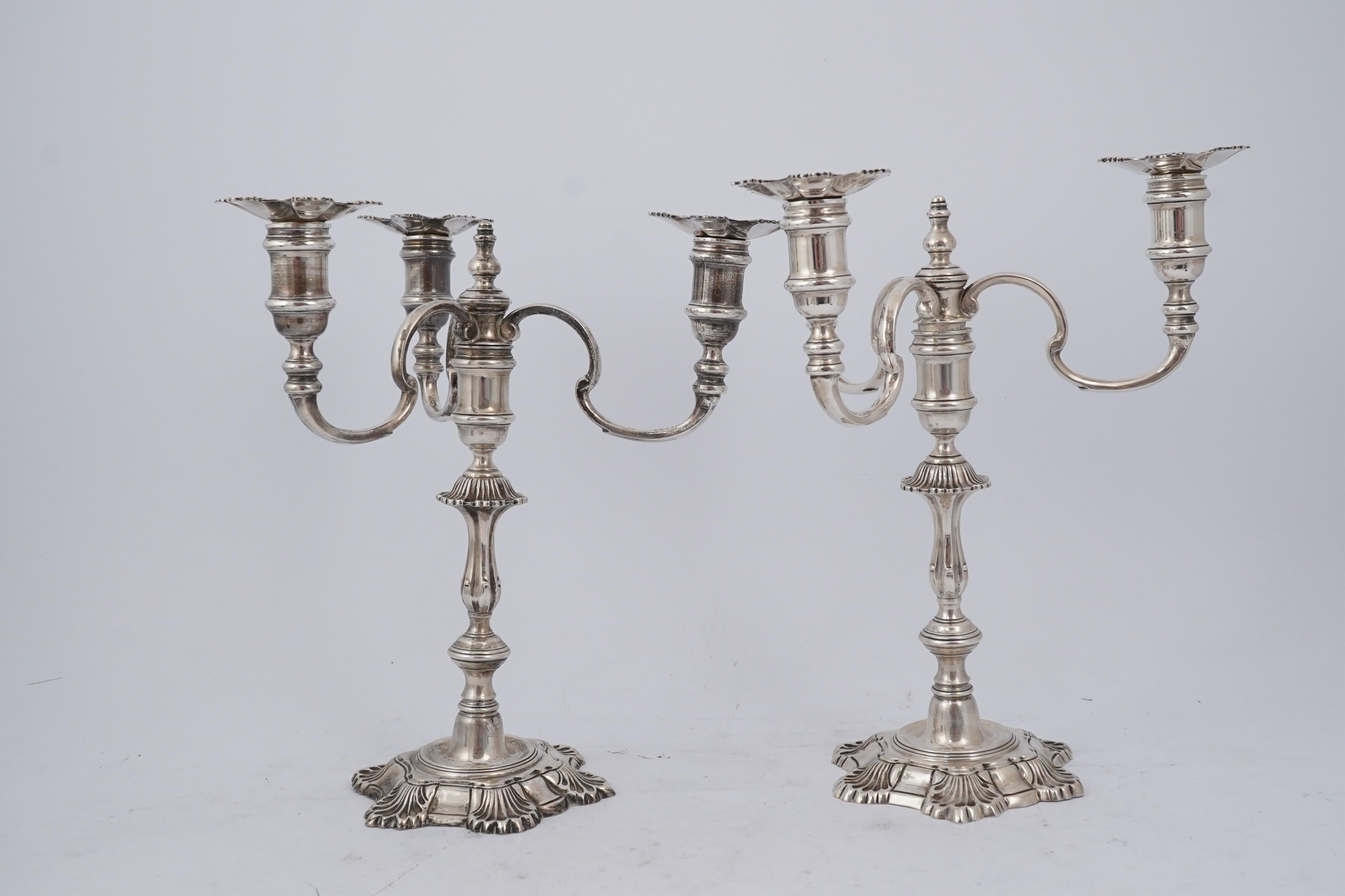 A pair of Elizabeth II cast silver three branch, three light candelabra, by J.B. Chatterley & Sons Ltd